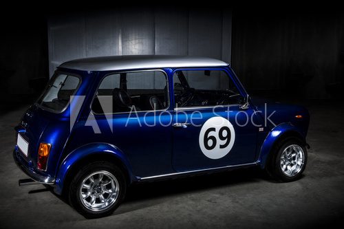 Iconic blue Mini Cooper in a parking area
