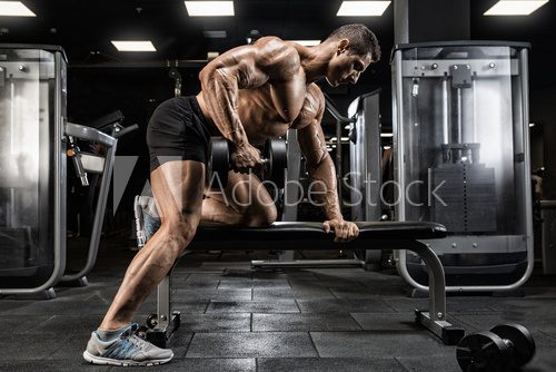 Brutal strong athletic men pumping up muscles workout bodybuilding concept background - muscular bodybuilder handsome men doing exercises in gym