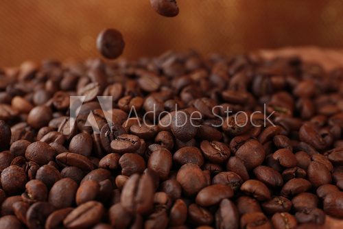 Coffee beans on table on brown background