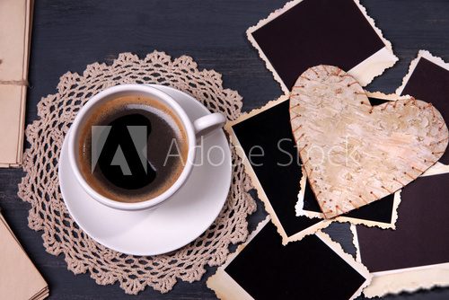 Composition with coffee cup, letters and old blank photos,