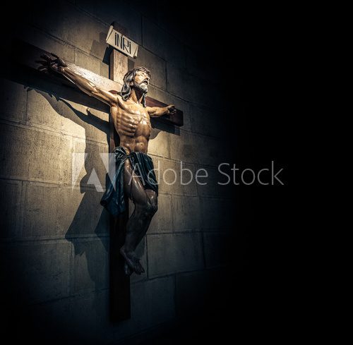 Crucifix in church on the stone wall.