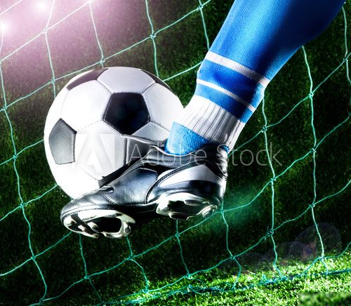 Foot kicking soccer ball