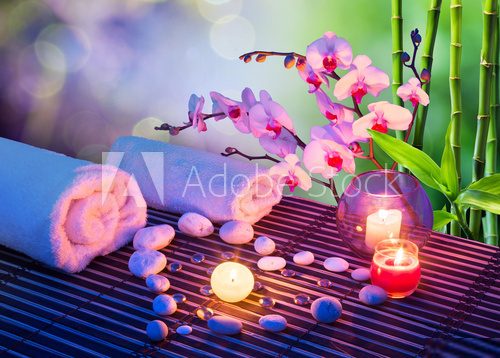 heart of stones massage with candles, orchids, towels and bamboo