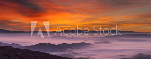 Idyllic mountain landscape at foggy dawn