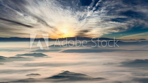 Idyllic mountain landscape at misty dawn