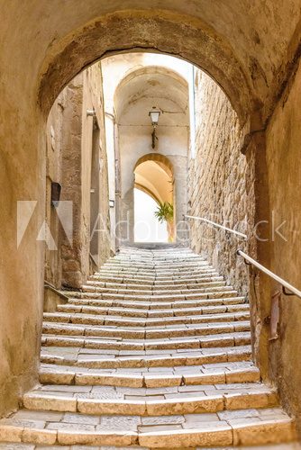 old stone steps and arch in the medieval village, Pitigliano, tuscany, italy