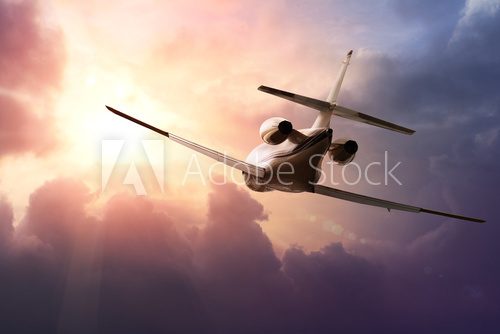 Private Jet PLane in the sky at sunset
