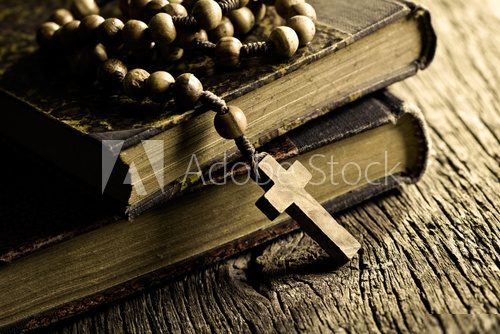 rosary beads on old books