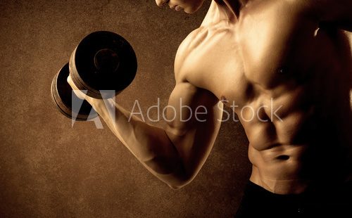 Muscular fit bodybuilder athlete lifting weight