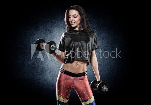Sports young woman with dumbbells