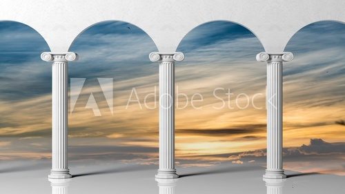 Three ancient pillars with sunset sky background.