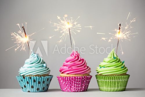 Three cupcakes with sparklers